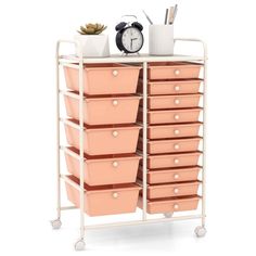 a white rack with pink drawers and a clock