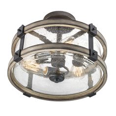 an outdoor light fixture with clear glass and metal details on the top, against a white background