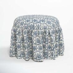 a blue and white ottoman cover with an intricate design on it's top, in front of a white background