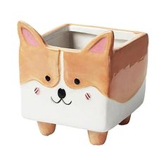 a ceramic dog shaped planter on a white background