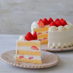 two slices of cake on plates with strawberries