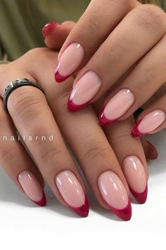 a woman's hands with red and pink nails