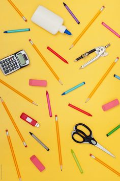 school supplies laid out on a yellow background