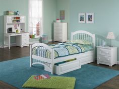 a child's bedroom with mint green walls and white furniture, including a twin bed