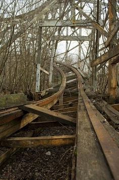 an old abandoned train track in the woods