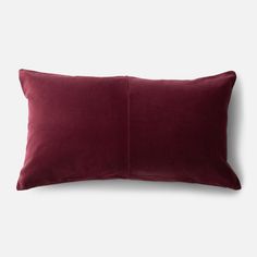 a dark red pillow on a white background