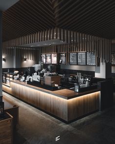 the interior of a restaurant with wood paneling on the walls and counter tops, along with menus