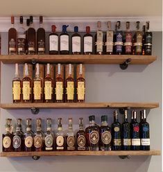 several shelves filled with different types of liquor