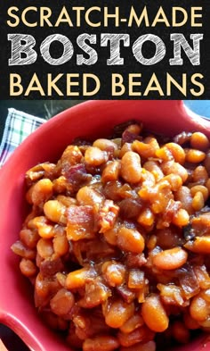 a red bowl filled with baked beans on top of a table