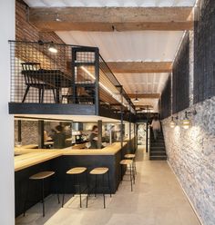 the interior of a restaurant with tables and stools