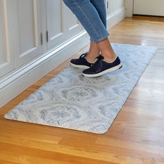 a woman standing on top of a white rug