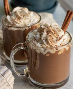 two mugs filled with hot chocolate and whipped cream