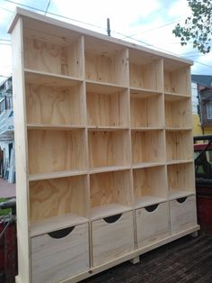 a large wooden shelf with drawers on top