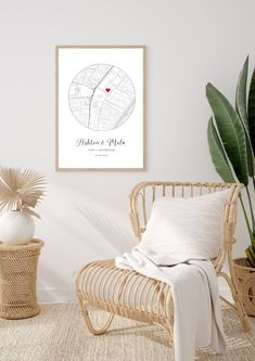 a room with a wicker chair, potted plant and a map on the wall