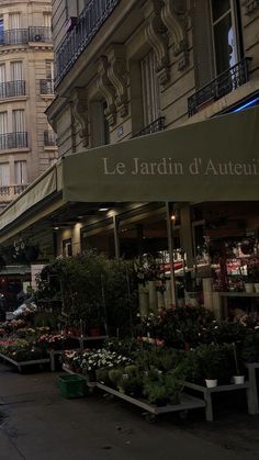 an outdoor flower shop in the middle of a city