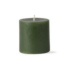 a green candle with a white top on a white background