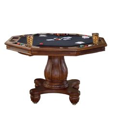 a wooden table topped with a black cloth and casino chips on it's legs