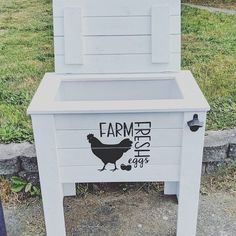 a chicken coop with the word farm fresh painted on it's side and an image of a hen