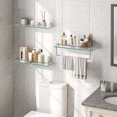 a white toilet sitting next to a bathroom sink under a mirror with shelves above it