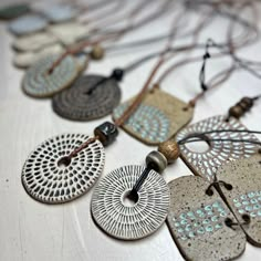 an assortment of necklaces are displayed on a table