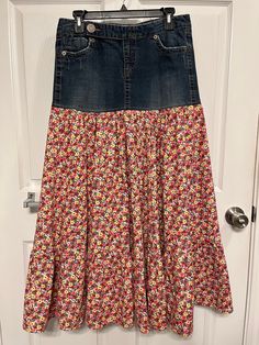 "This is a Repurposed denim skirt in a pink calico fabric.  The style is a Country chic, boho, hippie, 1970's and 1980's skirt style. The is a denim skirt with 6 panels in the main part of the skirt with a nice full bottom ruffle. The top part of the skirt is a recycled denim skirt with pockets and a zipper front closure. It is in a newly repurposed condition, please see the photos. The denim skirt is a recycled Blue Asphalt Jeans brand skirt. The size of the skirt is a size 7 on its tag.  I hav Skirts Made From Jeans, Casual Pink Patchwork Skirt, Denim Pink Skirt With Pockets, Cotton Lined Denim Skirt, Pink Cotton Patchwork Skirt, Cotton Tiered Denim Skirt With Lining, Jean Projects, Modest Attire, Upcycle Clothing