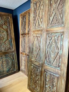 two wooden doors with intricate carvings on them