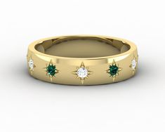 a gold ring with green and white stones on the inside, set in 18k yellow gold