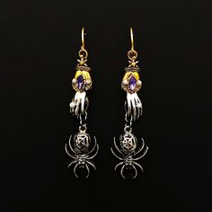 Add these gold gothic fun and spooky hand and spider dangle earrings to your jewelry collection and to your wardrobe. So interesting and funky, these handmade statement earrings are decorated with purple amethyst colored crystals and small simulated pearls.  Nobody will have ever seen anything quite like them before.  Great for parties, Halloween, or for any time you feel a little bit wicked.  APPROXIMATE DIMENSIONS Length: 3.5 inches (90mm) Width: 0.8 inches (21mm) Spooky Jewelry, Vintage Spider, Dark Jewelry, Spider Earrings, Amethyst Color, Color Crystal, Purple Amethyst, Cute Jewelry, Vintage Silver