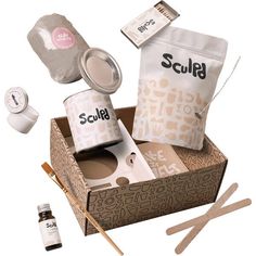 an assortment of items in a box with spoons and other things to put on them