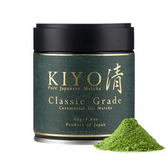 kiyowa green tea powder in a tin next to it's lid on a white background