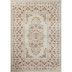 a white rug with red, orange and blue flowers on the center is in front of a