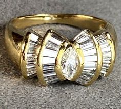 a close up of a gold ring with diamonds on the top and bottom part of it