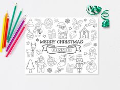 a christmas coloring book next to colored pencils and markers