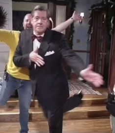 two men in tuxedos are dancing together