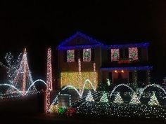 a house covered in christmas lights at night