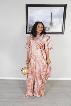 Elevate your wardrobe with this exquisite Blush Pink and Gold Metallic African Kaftan, a perfect blend of tradition and modern sophistication. Crafted with high-quality metallic fabric, this kaftan shines with a soft blush pink hue, accented by delicate gold patterns. It's designed for the woman who values both style and comfort, making it an ideal choice for weddings, galas, and other formal events. The structured neckline and flowing silhouette provide a regal, elegant look that's sure to make a lasting impression. Key Features Material: Premium Metallic Fabric: Offers a luxurious sheen that catches the light, creating a mesmerizing effect. Color & Pattern: Blush Pink Base: Soft and feminine, perfect for any skin tone. Gold Accents: Intricate gold patterns that add a touch of glamour and Latest Bubu Gown Style, Bubu Gown, African Kaftan, Bubu Gown Styles, Dress Blush Pink, Gown Style, Rich Fabric, Metallic Fabric, Kaftan Dress