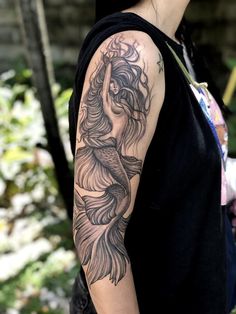 a woman with a tattoo on her arm