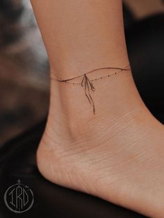 a woman's foot with a small tattoo on the side of her left ankle