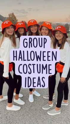 four girls wearing orange hats and holding a sign that says group halloween costume ideas on it