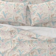 an image of a bed with floral print on it and two pillow cases next to each other