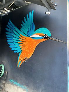 a colorful bird painted on the side of a building