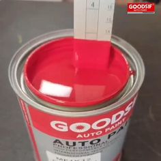 a red paint can with a sticker sticking out of it's lid that says good auto paint