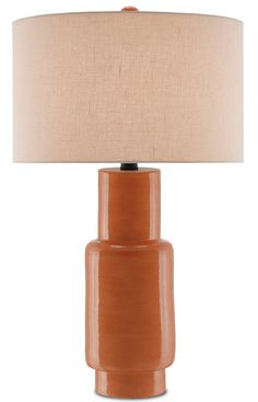 an orange table lamp with a beige shade on the base and a light brown drum