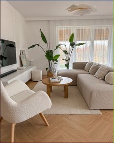 a living room filled with furniture and a flat screen tv on top of a wooden table