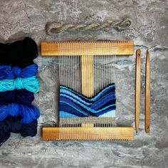 two skeins of yarn sitting on top of a table next to a pair of scissors