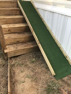 an outdoor ramp made out of wood and artificial grass is being used to slide down the side of a house