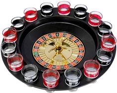 a casino rouleet filled with shot glasses on top of a black tray that has red and green cups in it