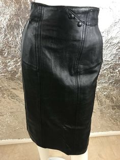 Women's vintage 1980's genuine black fitted leather high waist pencil skirt with back zipper.  Has side front pockets, full lining, and a back slit.  Size 8 (vintage sizing runs smaller than modern sizing) or small to medium, has NO stretch.  Pre-owned.  Good vintage condition.  WAIST=26 inches.  HIPS=36 inches.  ZIPPER LENGTH=9 inches.  SLIT LENGTH=8 inches.  LENGTH=26 inches. High Waist Pencil Skirt, High Waisted Pencil Skirt, Black High Tops, Leather Pencil Skirt, Black Pencil Skirt, Hair Colorist, 1980s Vintage, Black Fits, Leather Top