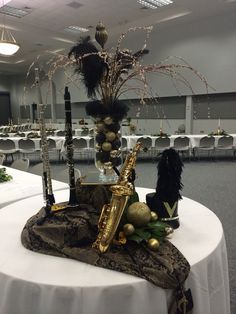 an arrangement of musical instruments and decorations on a table in a banquet hall or conference room