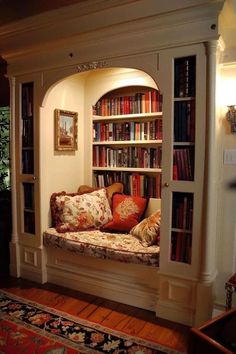 a room with a couch and bookshelf in it